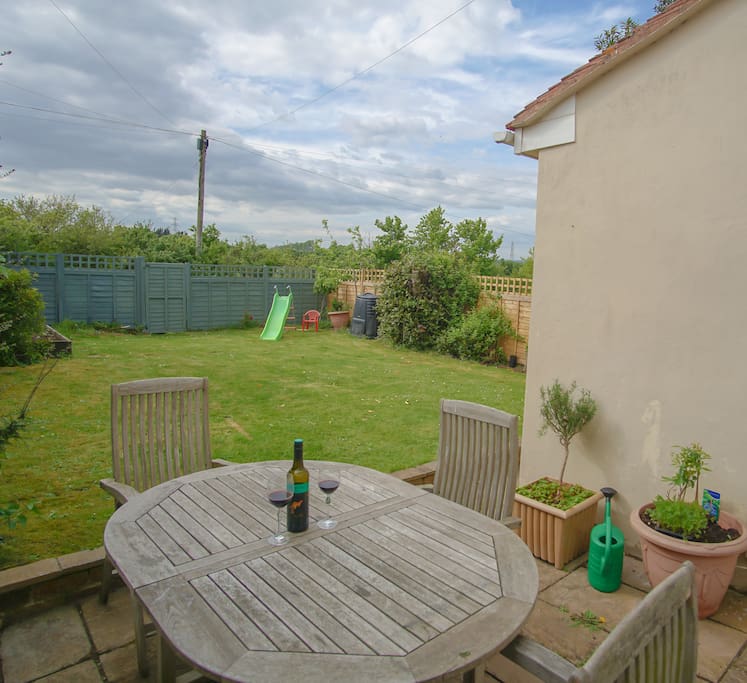 Back garden with children's slide and vegetable patch
