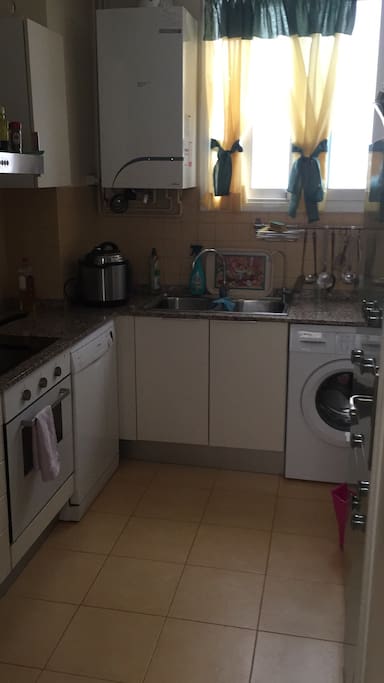 Kitchen with fridge, washing machine and dish washer. All you need.