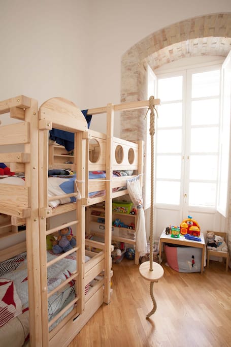 Childrens bedroom with 2 single beds, toys, playing area