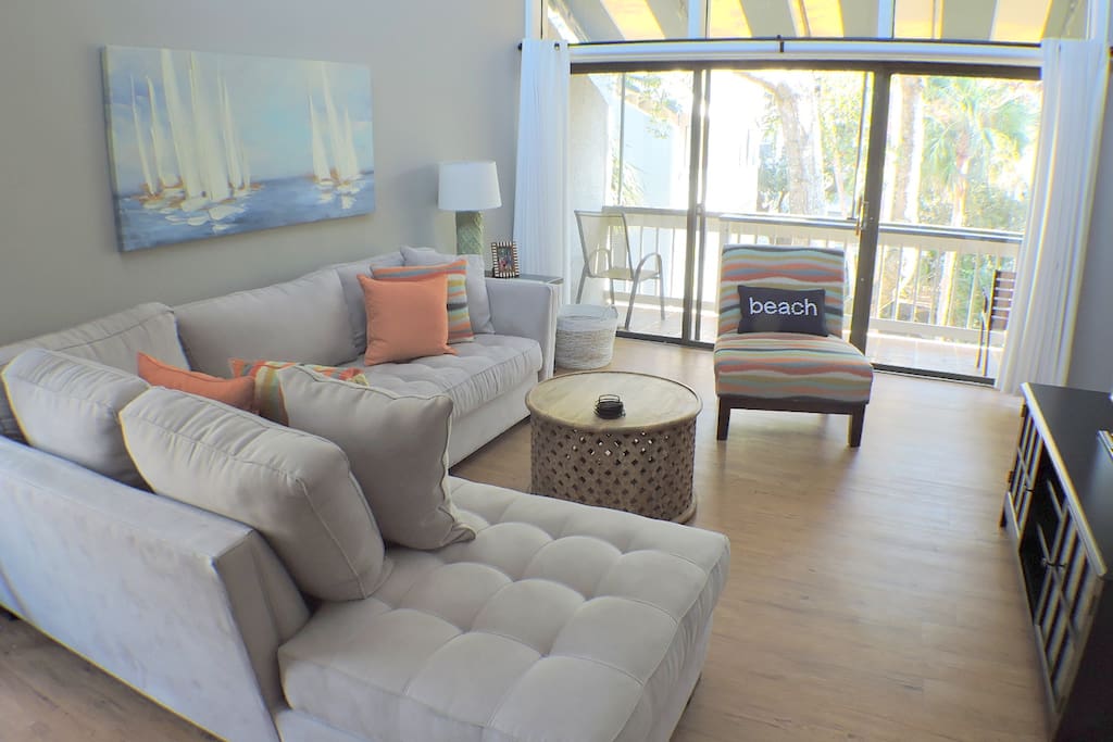 Comfortable living room also provides access to balcony.