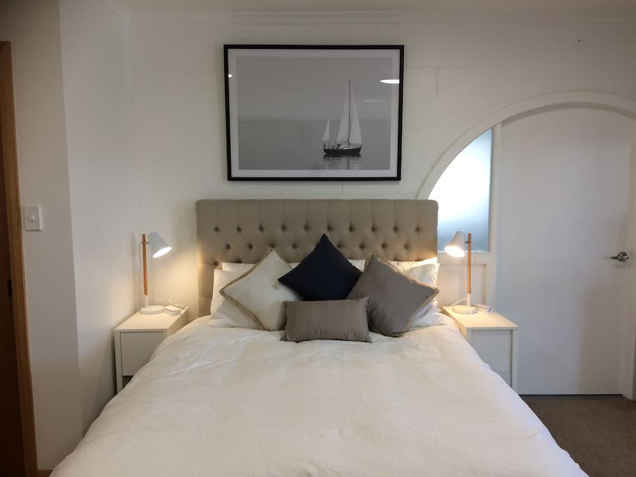 Master bedroom with door on the right leading to kitchen / daybed. Door on left leads to a small foyer space before the bathroom. This provides a good sound buffer between bedroom / bathroom.
