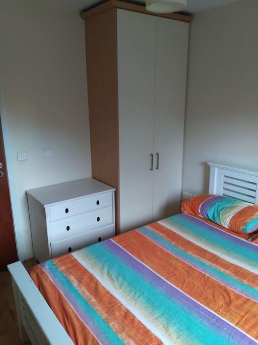 A wardrobe and a chest of drawers in the bedroom