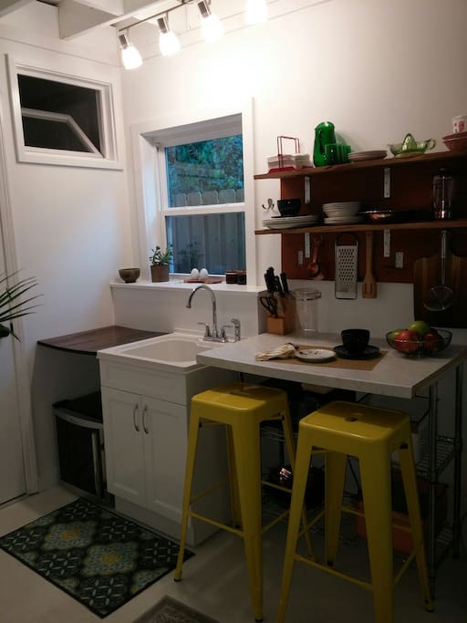 The kitchenette can seat 2 and double as a comfy work space.