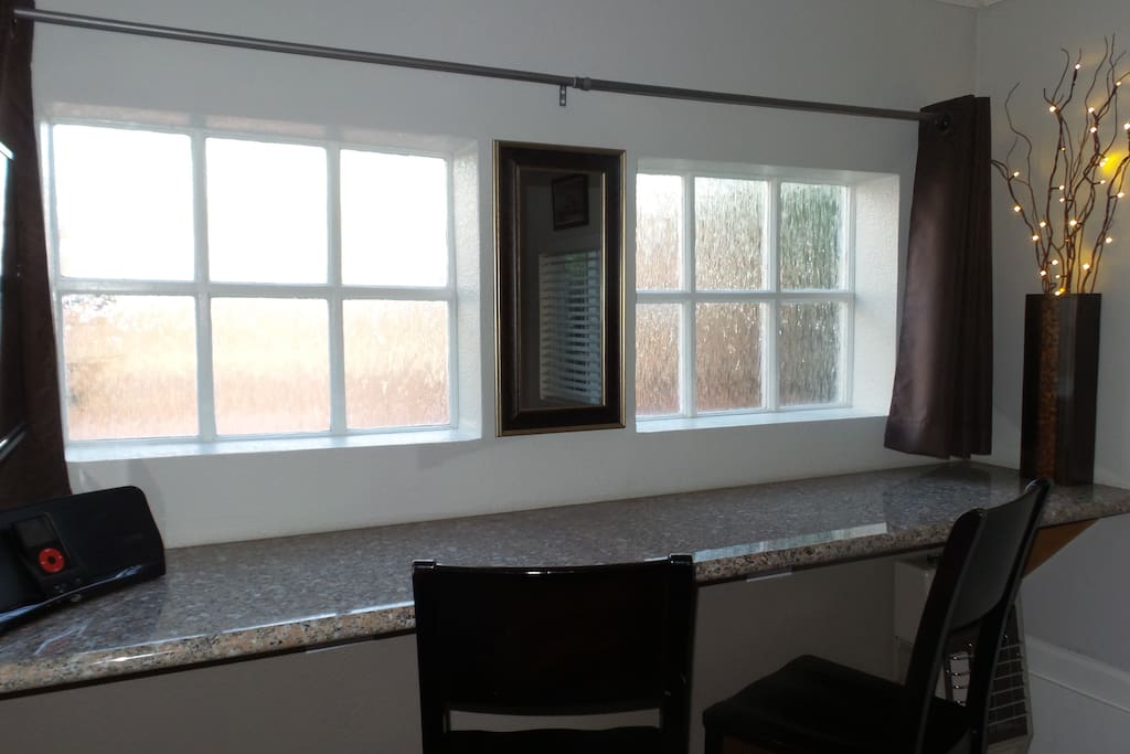 Decretive privacy windows at the front of the cottage over eating bar & workspace.