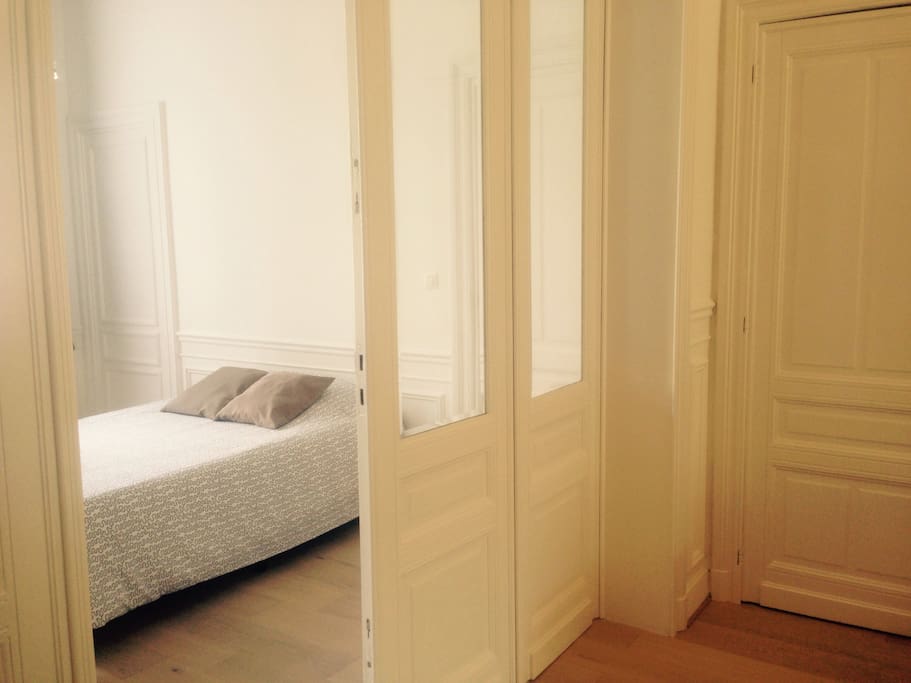The large and bright bedroom with a double bed, antique mirror, tv,...