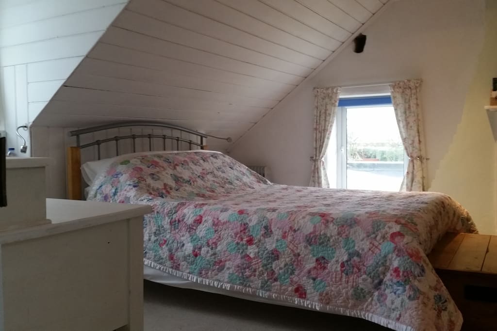 King size double bed with glimpse of the sea