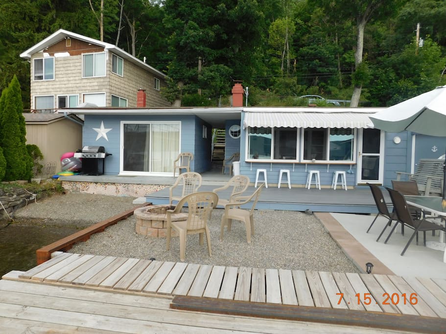 The view from the lake....the main cottage is on the right where the bar is and the bungalow is attached but on the left where you see the beach and the sliding glass doors)