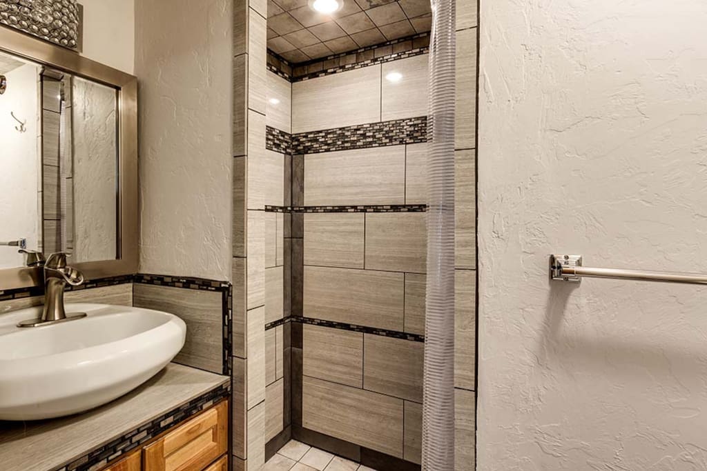 Fancy new double shower and cute vanity. Steve admits he spent too much time on the glitzy tile design. The lights are automatic and inviting,
The farm faucet on the sink could spray you if your in a bad mood. Has happened...