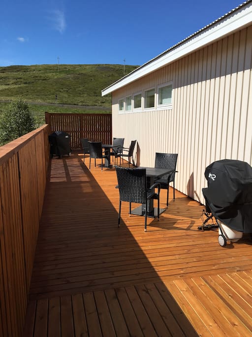 On the deck there is a Weber BBQ and tables and chairs.