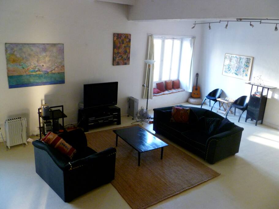 Looking down on sitting area, large flatscreen with large selection of dvd's and cable tv