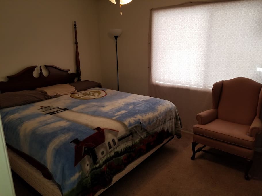 Here is your bedroom complete with sitting chair, tables on each side for both storage, beverages, or whatever you wish to place there.