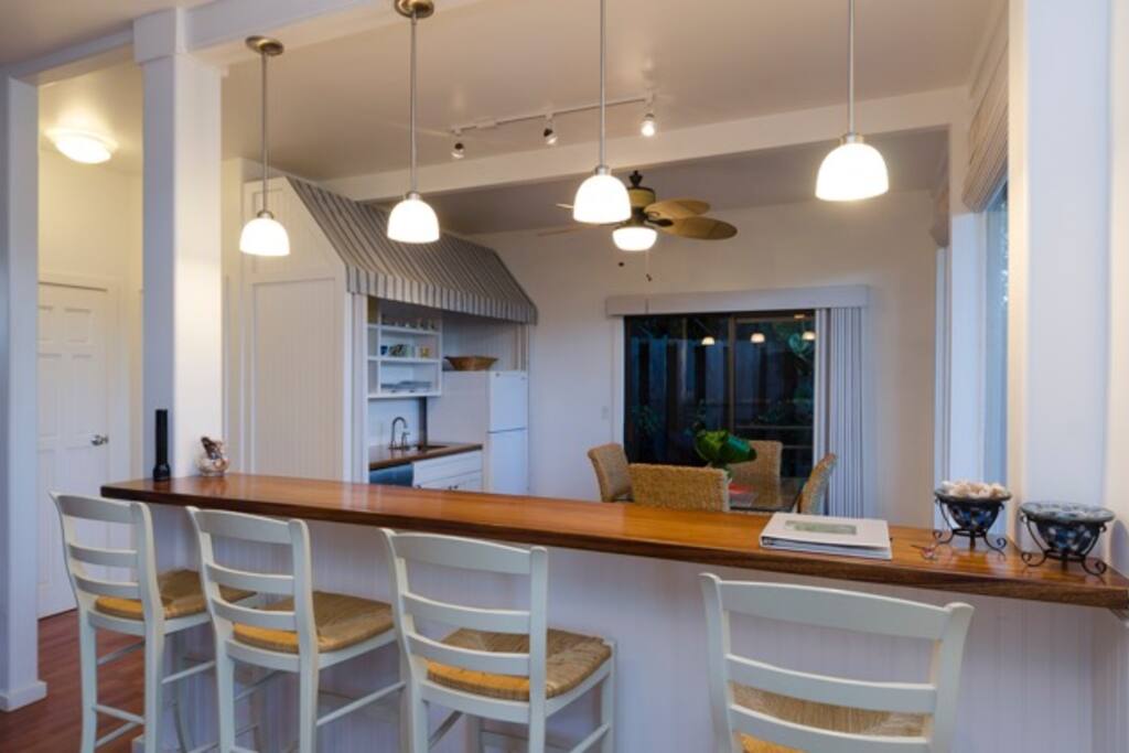 Bar overlooking dining and kitchen area