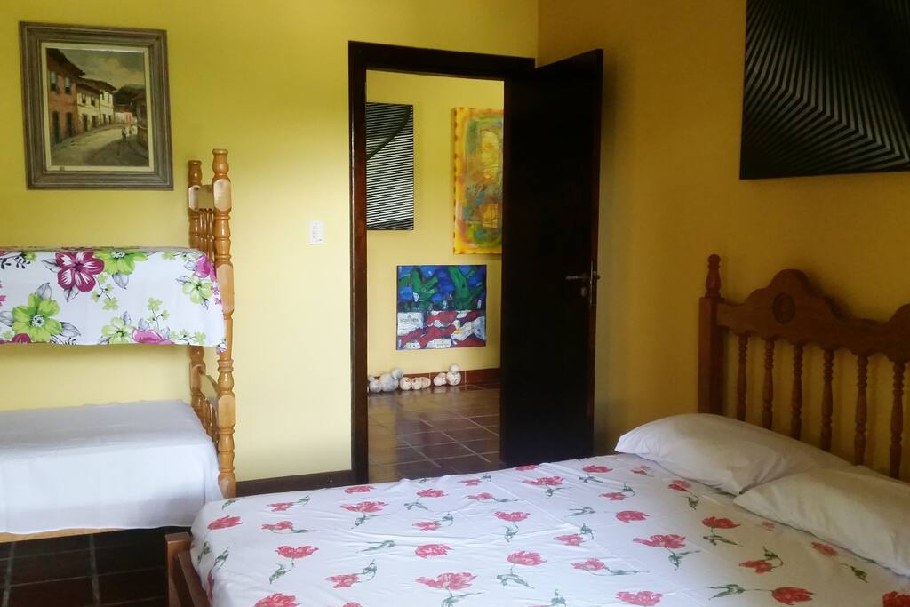 Com uma cama de casal e uma beliche, o quarto é do tamanho ideal para acomodar com conforto uma família.