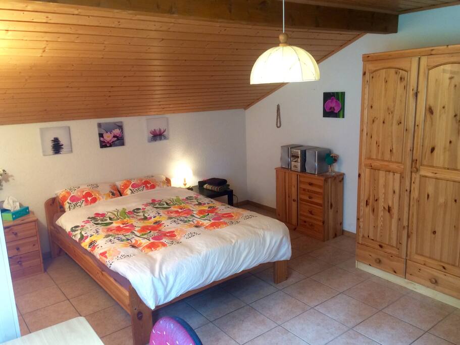 Top floor bedroom with queen bed and desk space