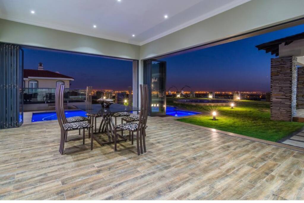 Dining area with pool and city views