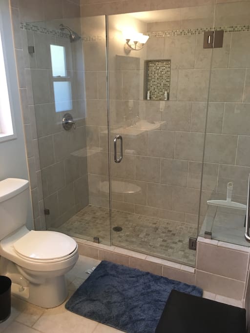 Beautiful tile shower with glass doors.