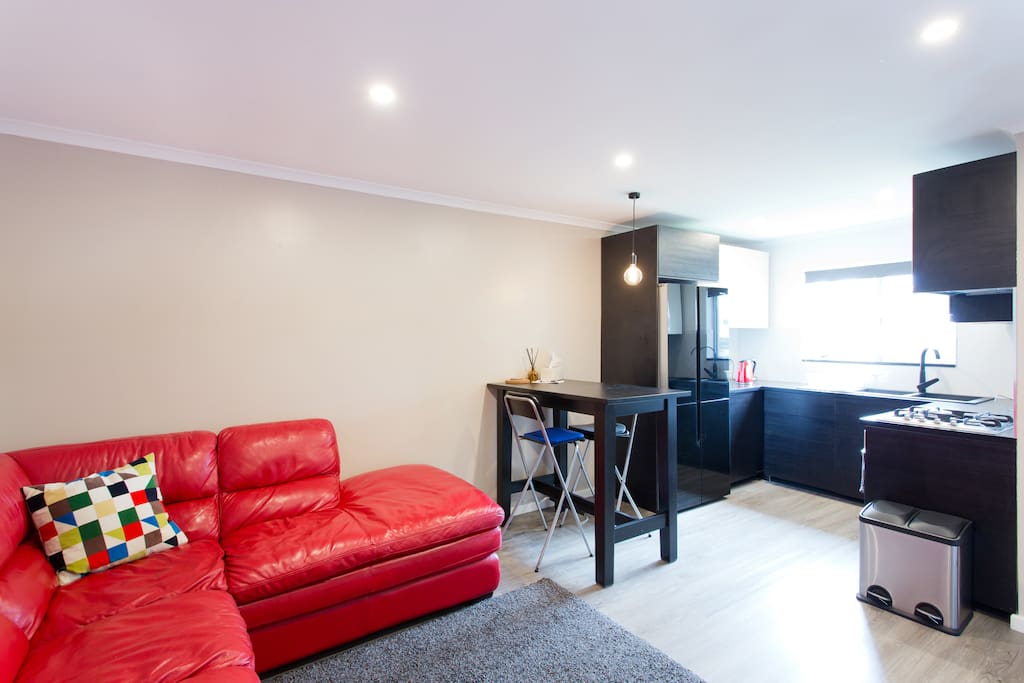 Modern new total renovation includes a smick kitchen with everything you need to prepare a meal and make yourself a drink. You can flip open your laptop while you sit on a bar stool at the table.