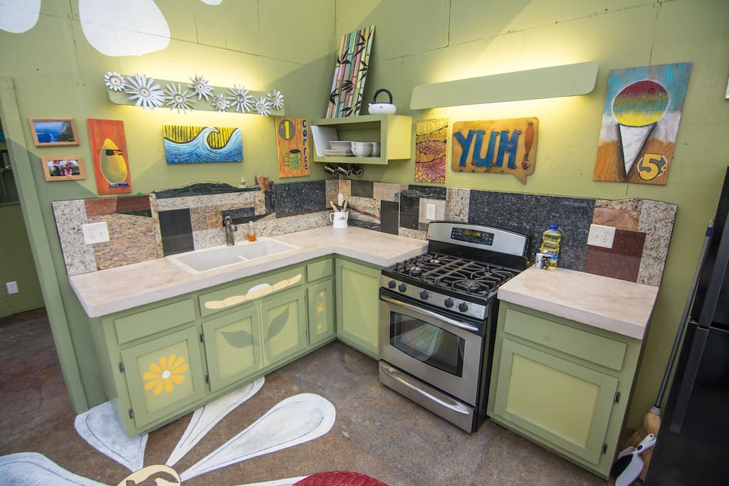 Kitchen and Common Area:
Gas Stove, Refrigerator with Ice Maker, Kitchen Table, Concrete Countertop, Custom Mosaic Backsplash, Art Deco, Artistic Concrete Floor. Greenhouse