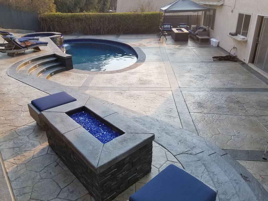 Backyard; pool, jakuzzi, fire pits and deck.