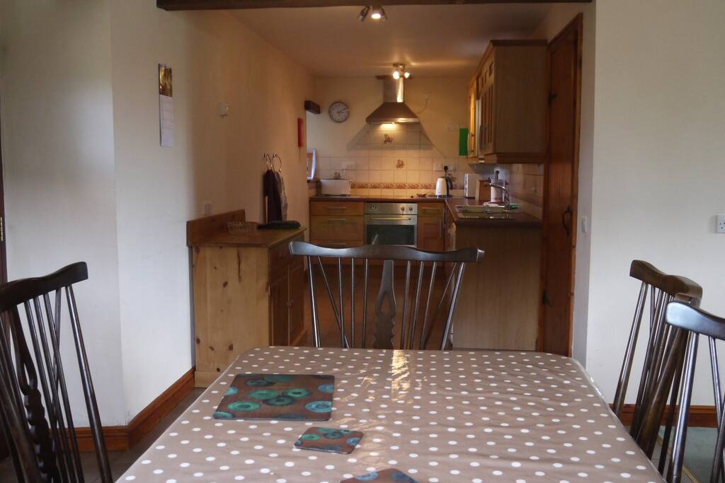 Dining area with kitchen in background