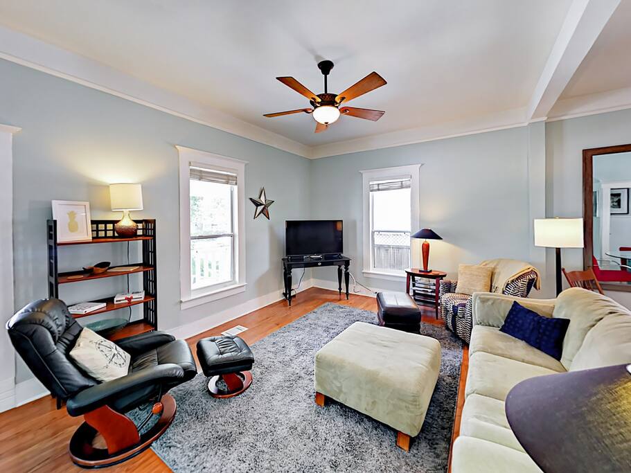 Living Room with sofa, chair, rocker, flat screen TV, and ceiling fan.