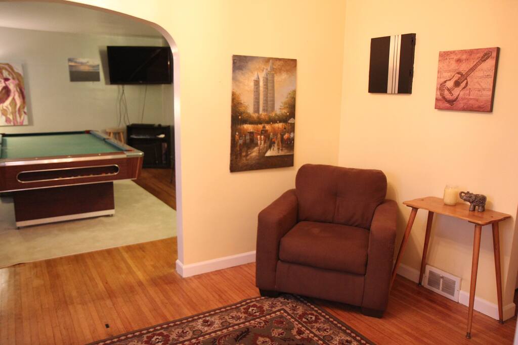 Dartboard above chair in sitting room.