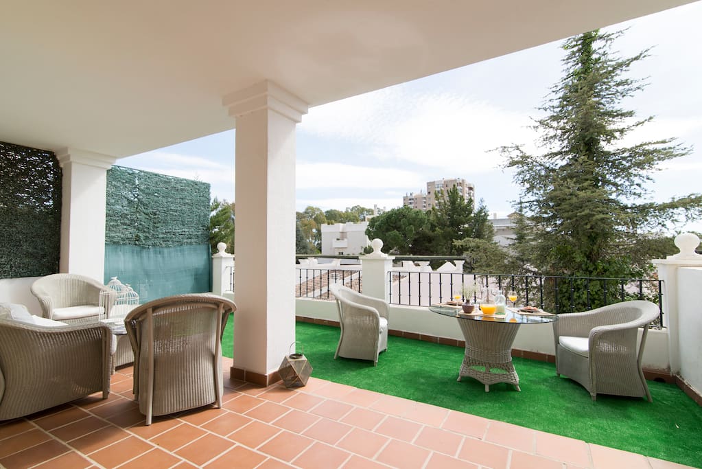 Large sunny terrace, with lounge and outdoor dining area.