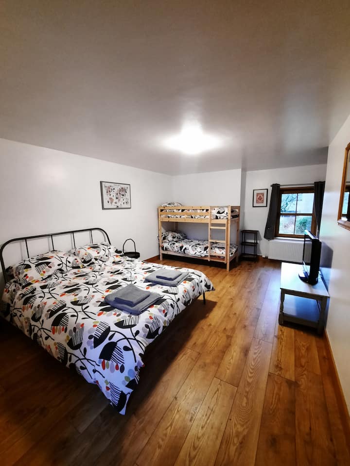 Third bedroom with a king-size bed and a small bunk bed. The bunk bed is only suitable for children.