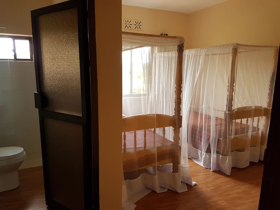 One of the twin rooms with private bathroom to the left