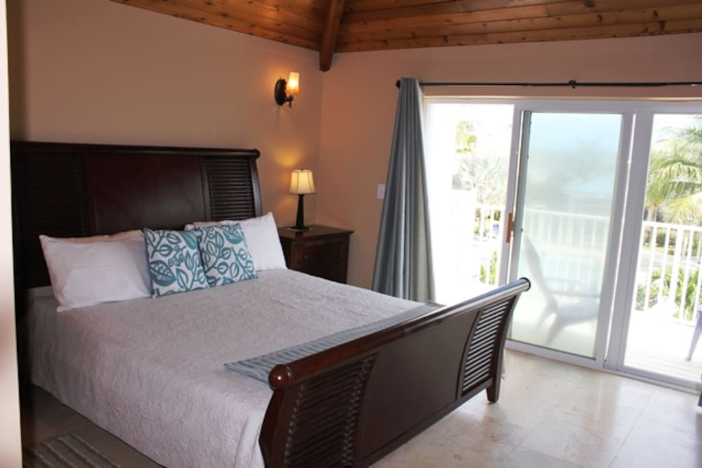 The large master suite has a walkout balcony that overlooks the pool & is equipped with a King size bed & has plenty of room for an additional queen air mattress that is ideal for small children.