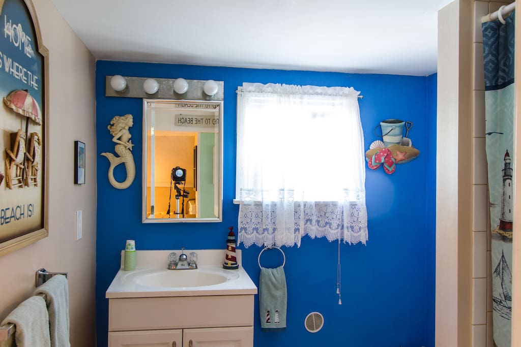 A bright and sunny bathroom with a pop of color!