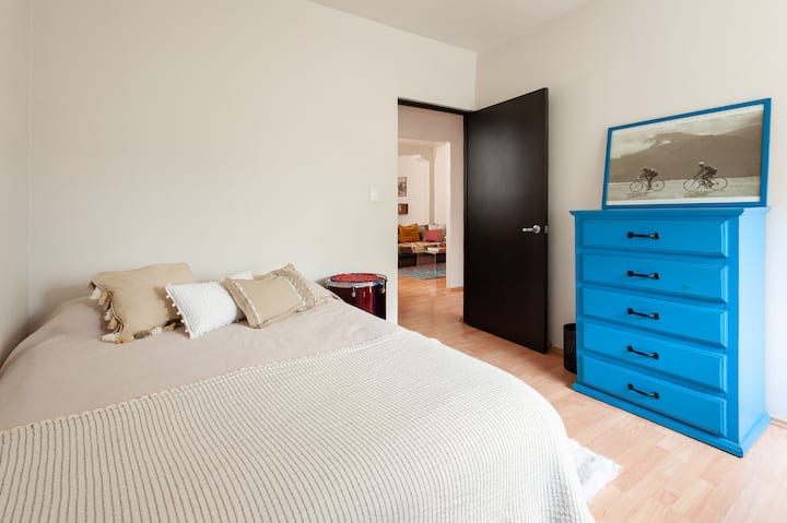 第二间卧室：全尺寸床、梳妆台和书桌。