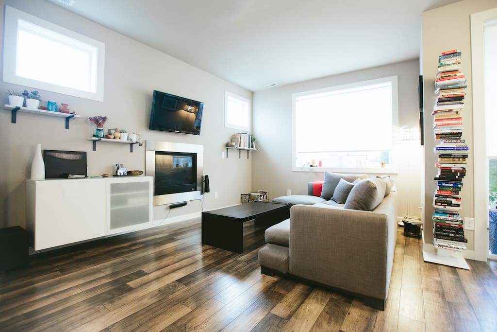 Living room with comfy couch and 40" flat screen tv, cable, blu ray and home theatre system