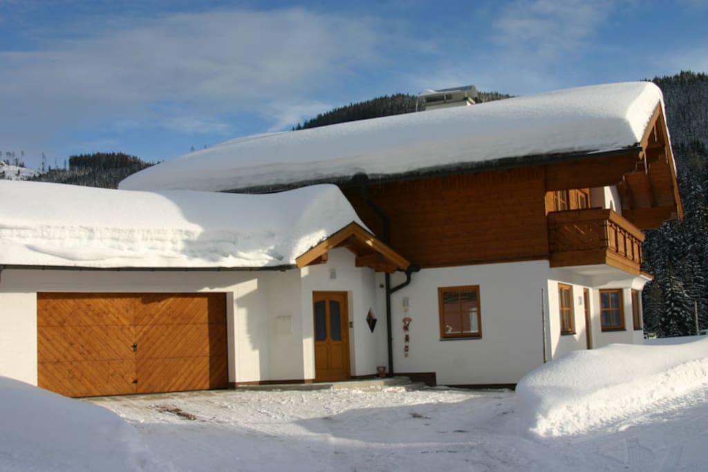 View of the front of the chalet after a heavy snowfall in Ski Amade near Salzburg.