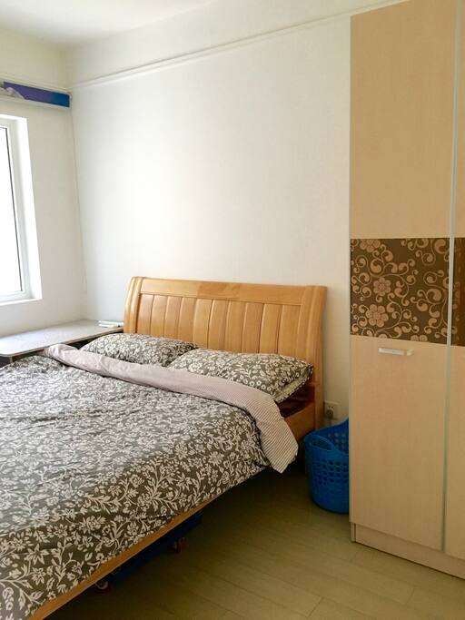 Private bedroom with double bed, closet, and small desk