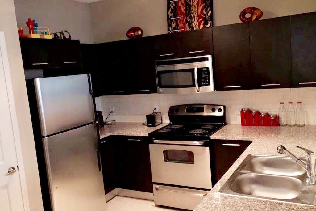 Kitchen - Microwave, Oven, Refrigerator, Dishes, Utensils, and Cookware.
