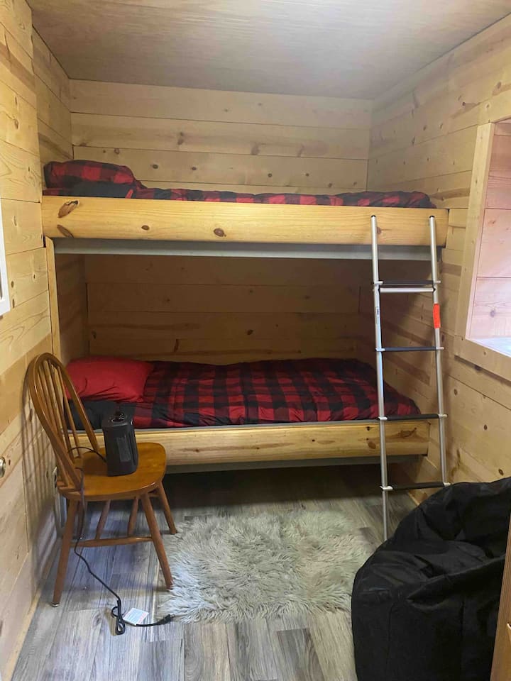 Bunk room with two twin beds, bottom floor off family room next to full bath. Good size for kids and adults