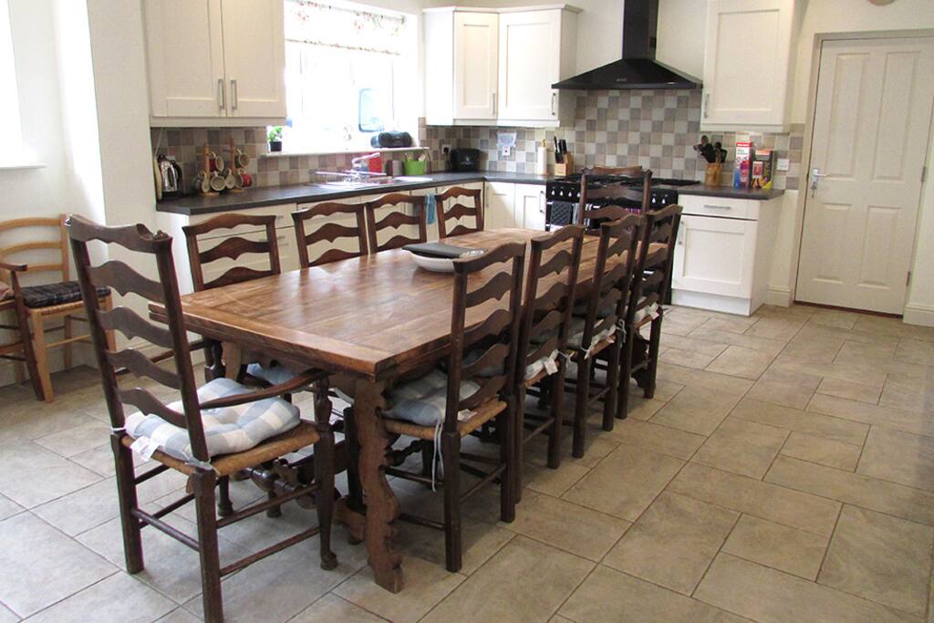 The Kitchen is a superb large room with range cooker, large fridge freezer, a second fridge, washing machine, dryer, dishwasher, microwave, fitted units and lots of utensils. Furnished with an 8’ extendable table seating at least twelve, Welsh dresser and wooden settle.