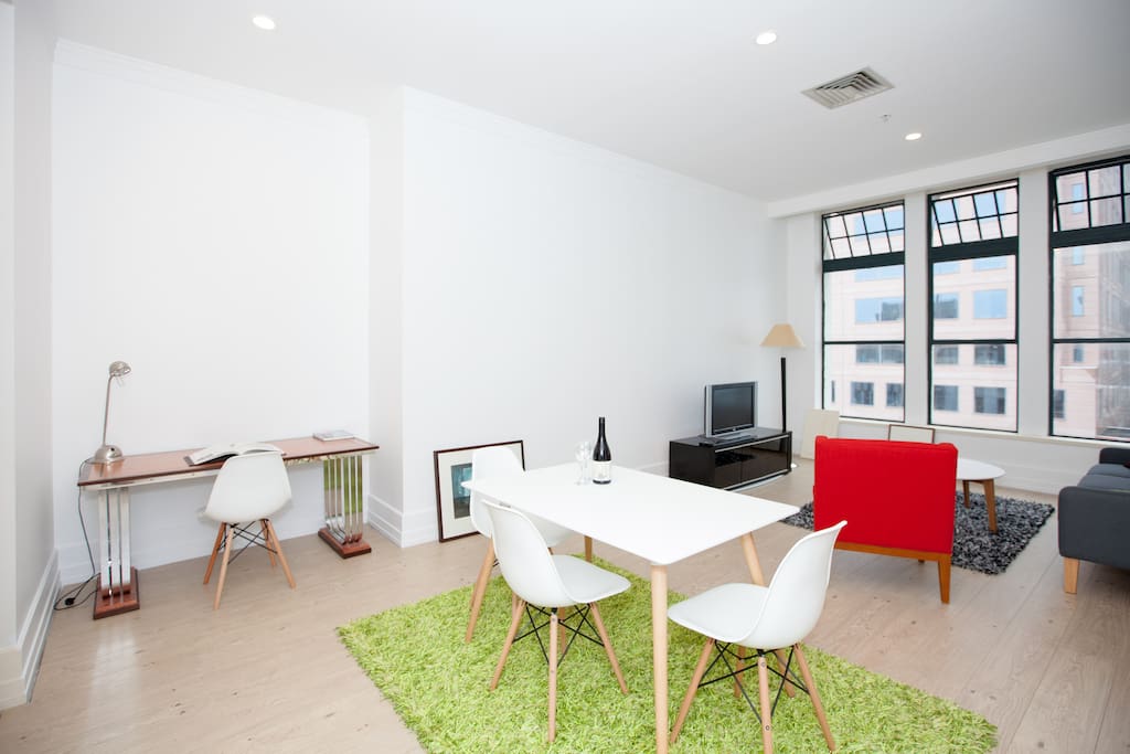 A spacious and modern living room with work space