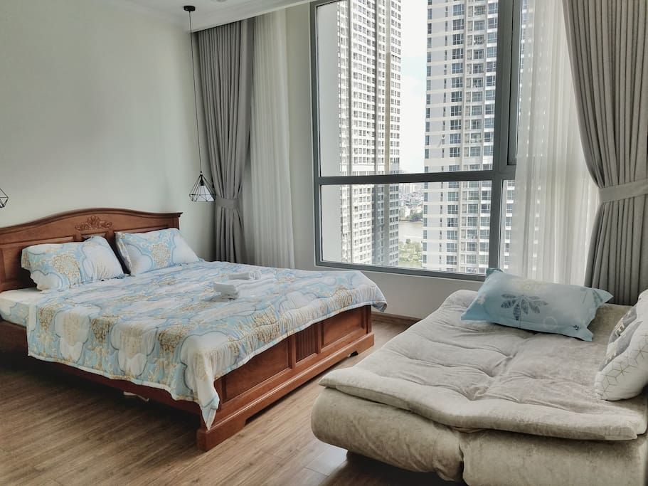 Queen bed and sofa bed in large bed room