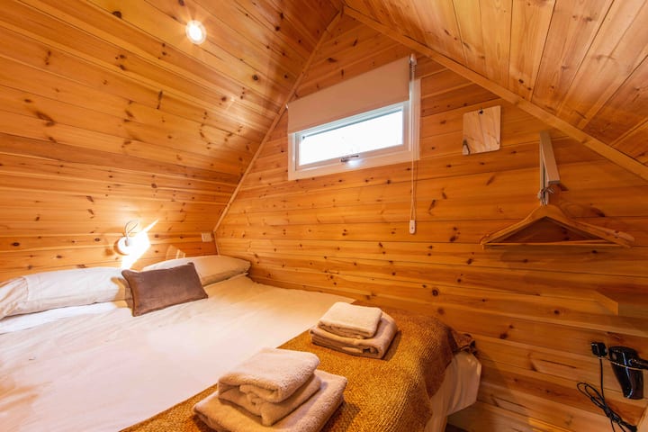 Bedroom with hanging space, under bed storage and hairdryer 