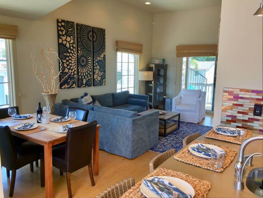 Dining area seats 7 guests..., 3 at bar and 4 around rectangular dining table.