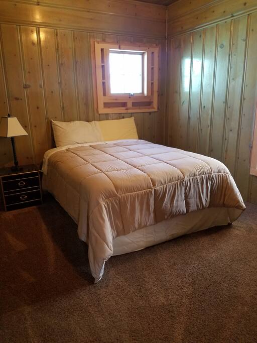 Queen bedroom with original knotty pine walls
