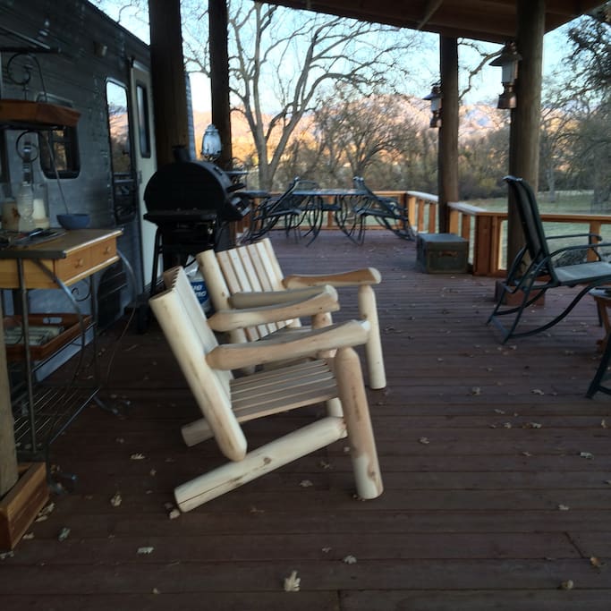 Enjoy the quiet with a glass of wine (BYOB) on our beautiful deck. Here, most of your time is spent outside. Sleeping space is in attached trailer.
