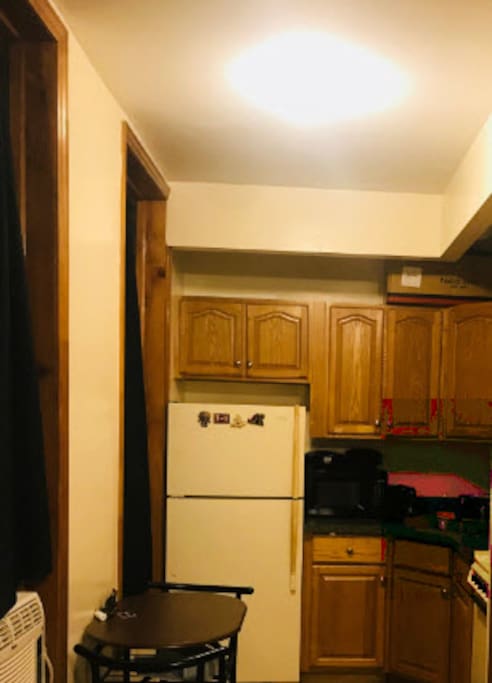 Eat in kitchen with dining table for two, coffee grinder, coffee maker, microwave etc.