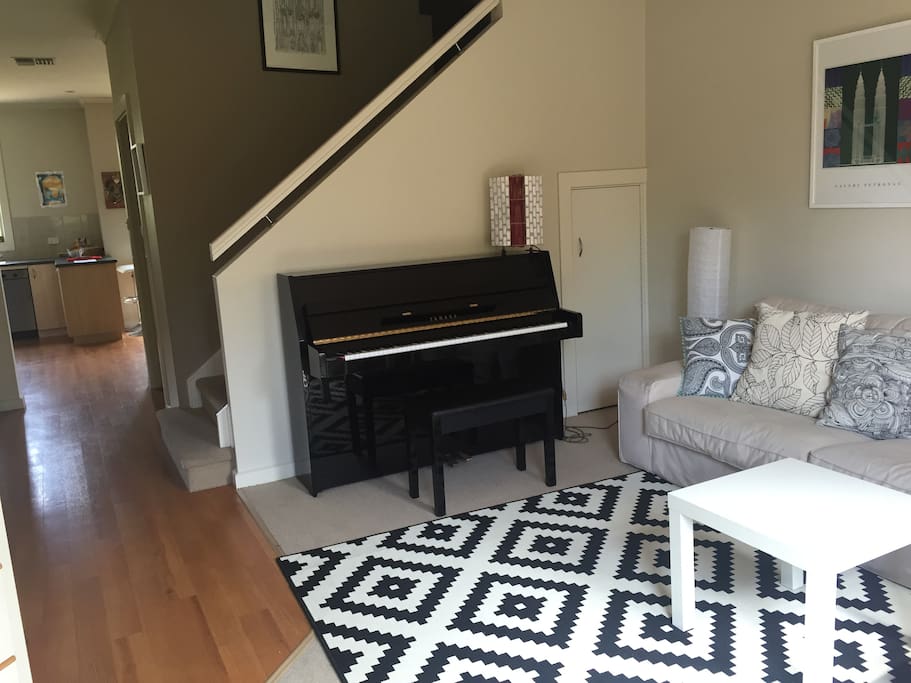 Comfortable sitting room with piano.