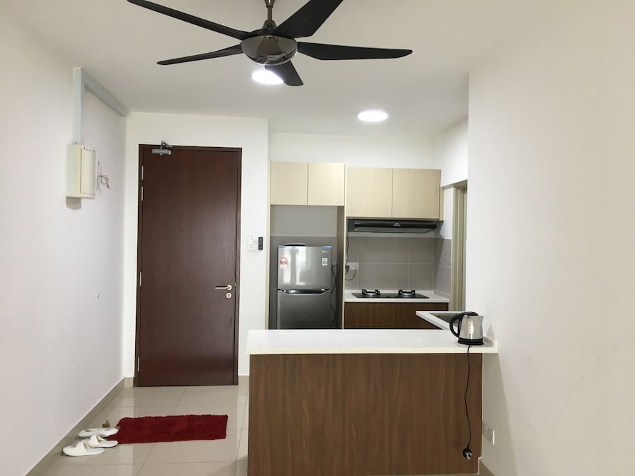 Kitchen complete with refrigerator, and cooker hob and hood.