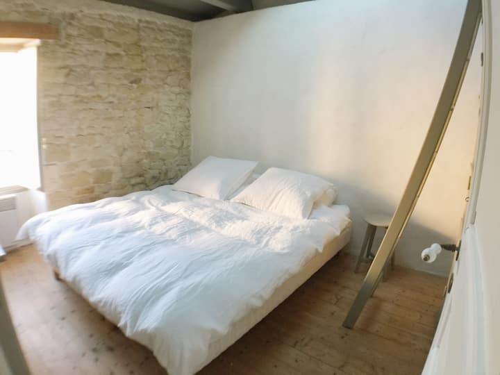 La habitación gris con una cama doble y una litera.