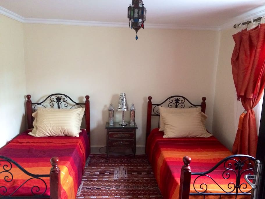 Private guestroom set up with twin beds.