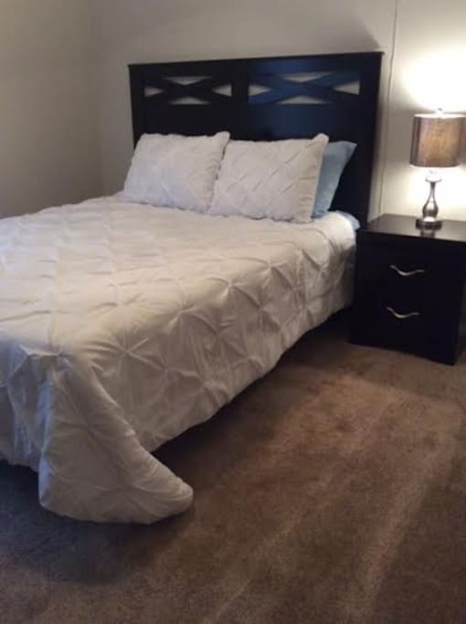 We changed the comforter out. It is no longer white as pictured. The night stand has also been moved to the other side.